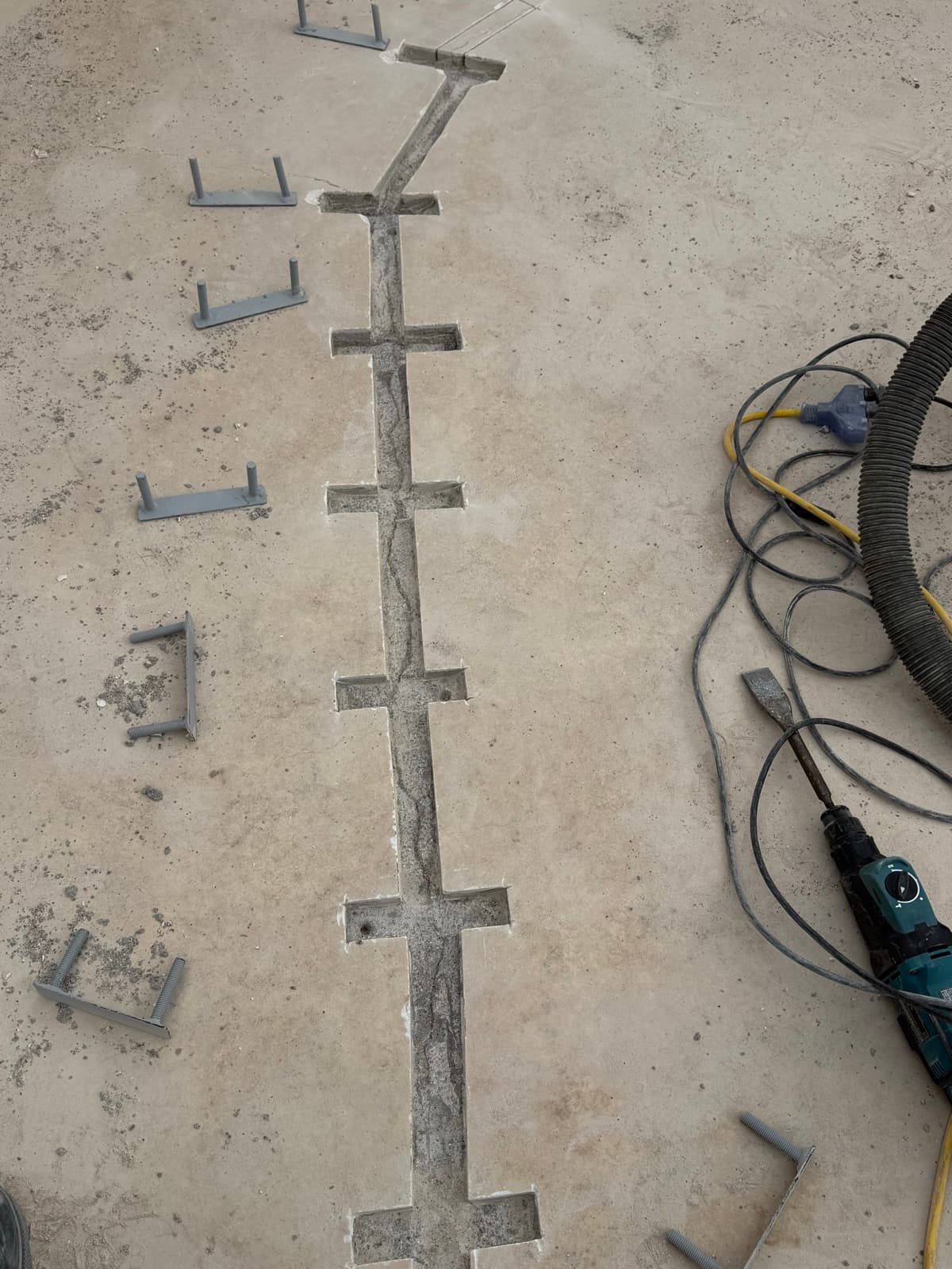 Structural pool crack repair — staples set across a crack before bonding and sealing