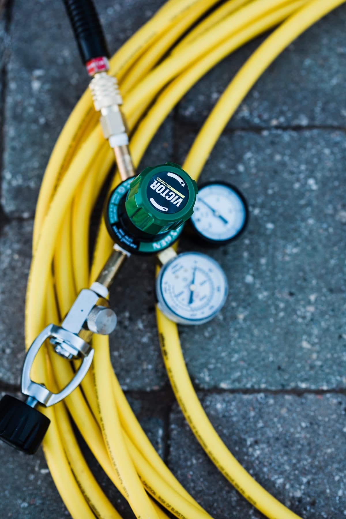 Pressure-testing regulator and gauges used to test pool plumbing lines