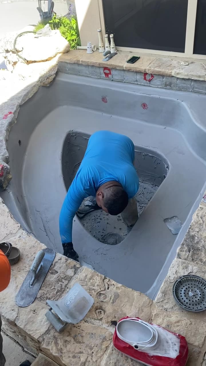 Aquatic Leak Detection resurfacing a spa interior by hand